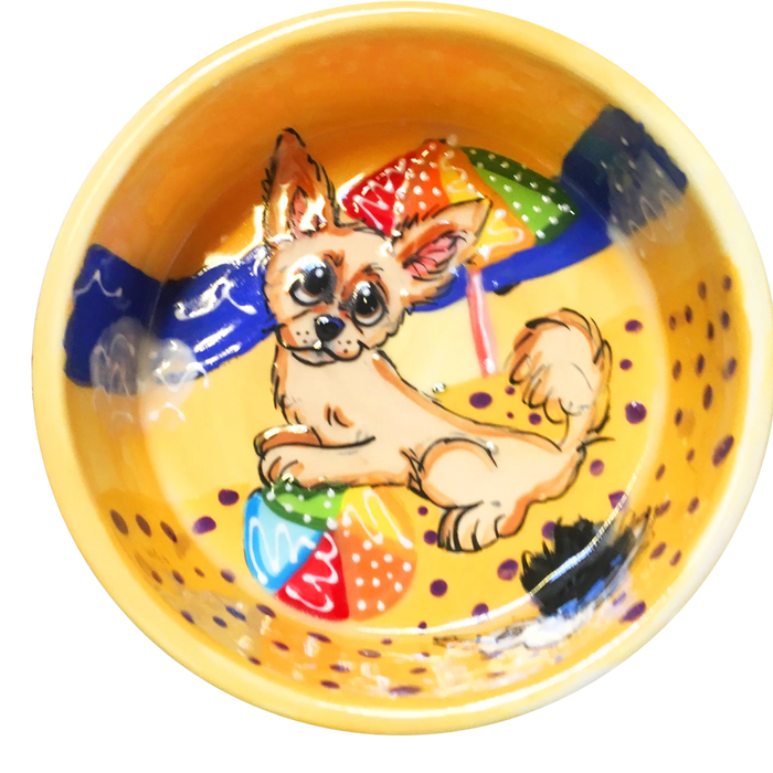 image of chihuahua playing with beach ball on ceramic yellow bowl with beach background hand painted by faux paw artist Debby Carman