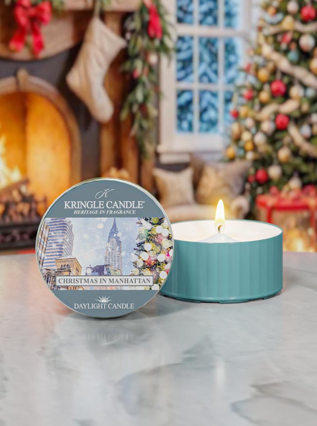 Kringle Candle Christmas in Manhattan candle with packaging in a festive setting.