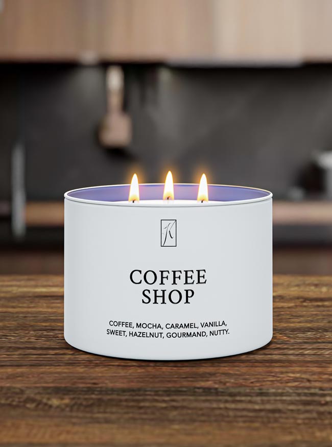 Candle labeled 'Coffee Shop' with flames on a wooden surface