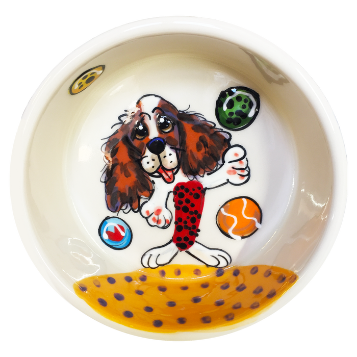 Image of cavalier king charles spaniel playfully ready for fetching tennis balls at the beach hand painted on ceramic pet bowl by faux paw productions artist Debby Carman