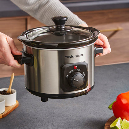 Morphy Richards slow cooker held by a person in a kitchen setting
