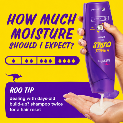 a promotional graphic featuring aussie miracle curls shampoo being dispensed into a hand against a bright yellow background. the design includes a moisture level indicator and a roo tip recommending shampooing twice to remove days-old build-up for a fresh hair reset.