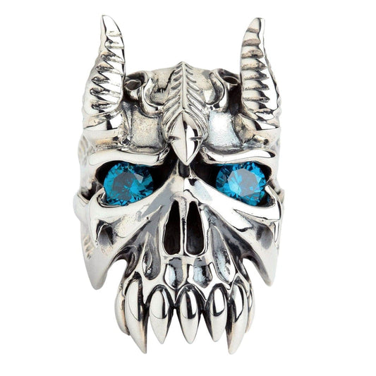 A large sterling silver bison horn demon ring with brilliant blue gemstone eyes and large, sharp fangs.