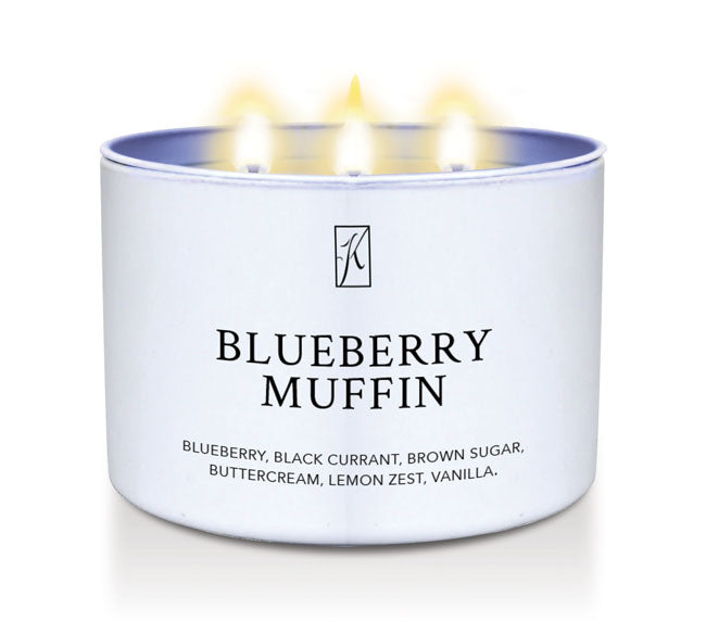 Candle in a white container labeled 'Blueberry Muffin' with a logo on a white background