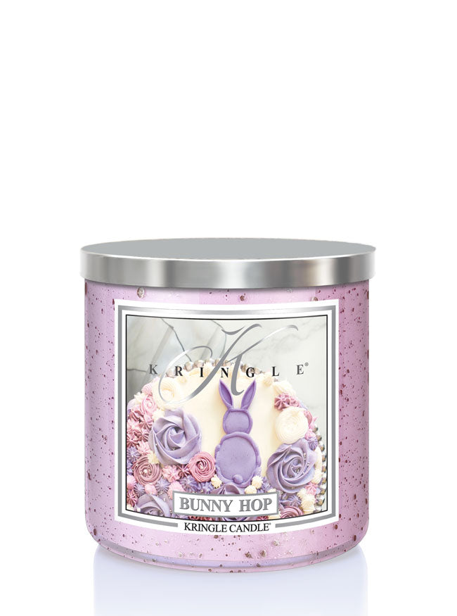 Kringle Candle with decorative label featuring a bunny and flowers on a white background