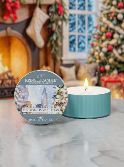 Kringle Candle Christmas in Manhattan candle with packaging in a festive setting.