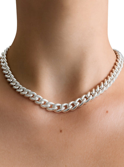 Tjej som bär ett chunky kedje halsband i äkta silver av modell Pansar.