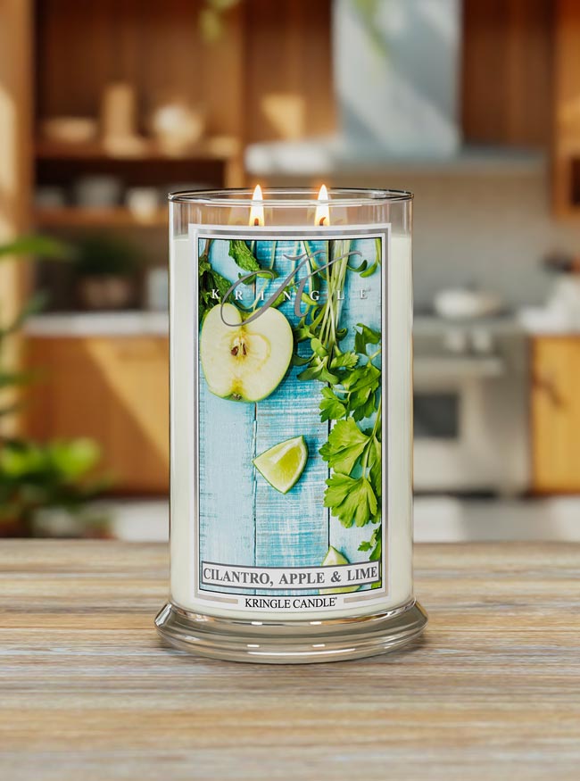 Kringle Candle with Chervil, Apple & Lime label on a wooden surface with a kitchen background