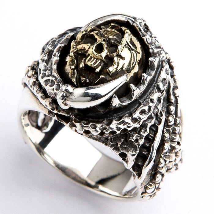 A side profile of the gothic skull and claw ring, showing its intricate, reptilian texture.