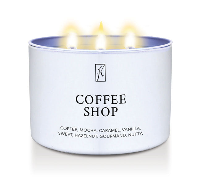 Candle in a white container labeled 'Coffee Shop' with flames on a white background