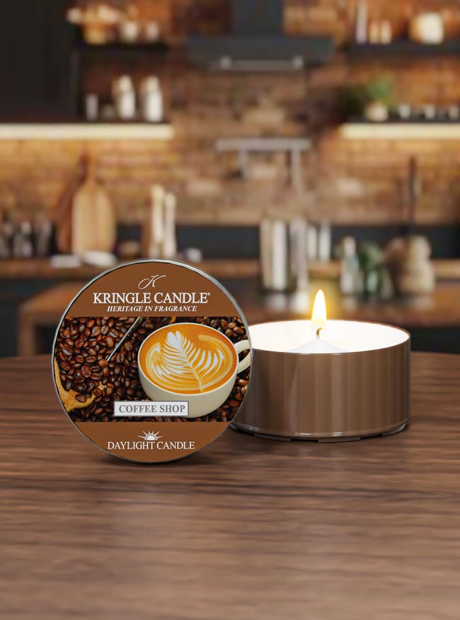 Kringle Candle Coffee Shop candle on a wooden surface with a blurred bar background