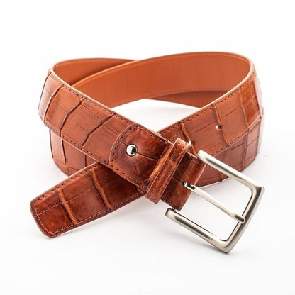 Handcrafted cognac crocodile belt displaying natural scale pattern with brushed silver buckle