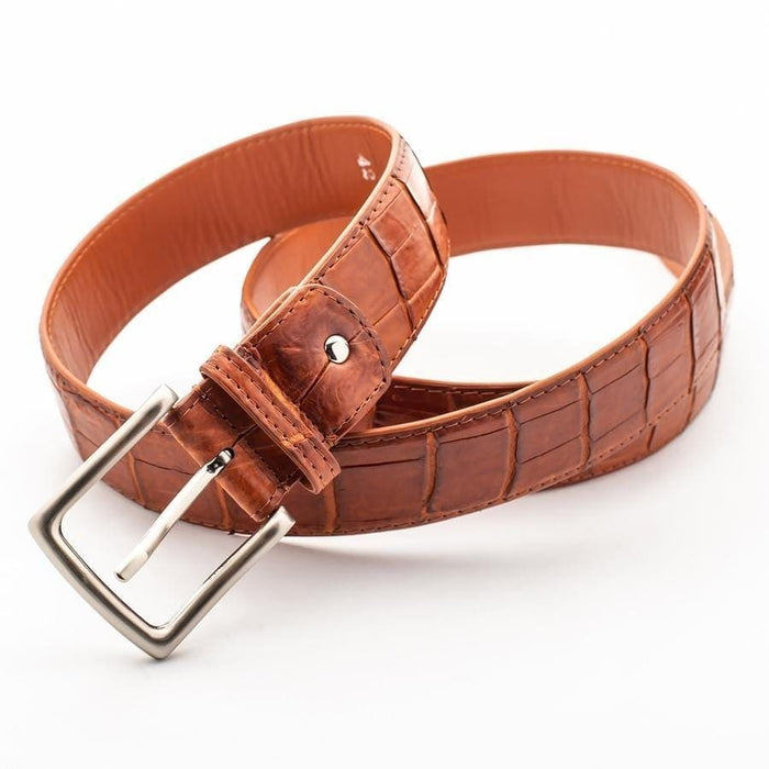 Exotic crocodile skin belt in cognac brown looped to show full length and tan leather lining