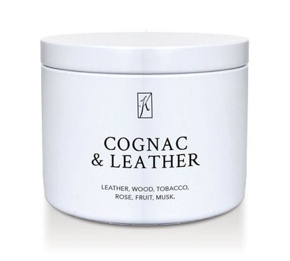 White candle tin container of 'Cognac & Leather' fragrance on a white background