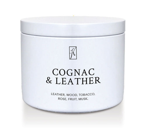 White candle tin container of 'Cognac & Leather' fragrance on a white background