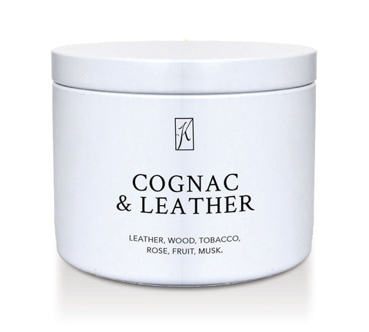 White candle tin container of 'Cognac & Leather' fragrance on a white background