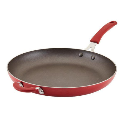 The Cook + Create Nonstick Frying Pan is a high-performance red frying pan made from durable aluminum, equipped with a long handle and a handy helper handle for versatile cooking.