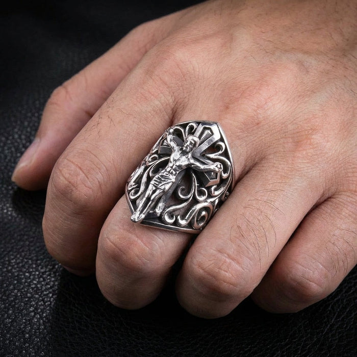 Sterling silver crucifix ring worn on middle finger showing bold 1.5 inch face