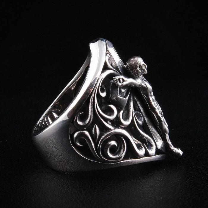 Back angle view of men's sterling silver religious ring with ornate scroll details