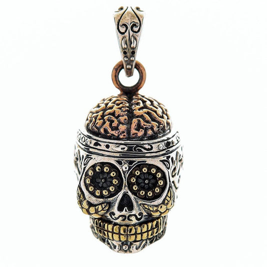 A multi-metal Day of the Dead skull pendant in sterling silver, with a detailed copper brain and warm brass teeth.