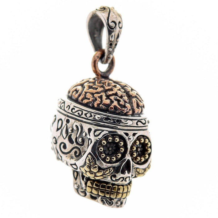 A unique sugar skull pendant with an exposed copper brain, a stunning piece of Mexican folk art jewelry.