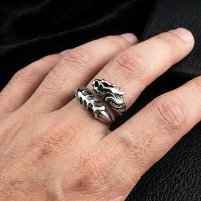 Silver dragon armor ring with detailed sculptural dragon head design worn on a man's finger against a black leather background