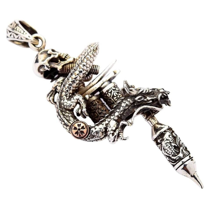 Handcrafted dragon skull tattoo machine pendant showing brass accent detail