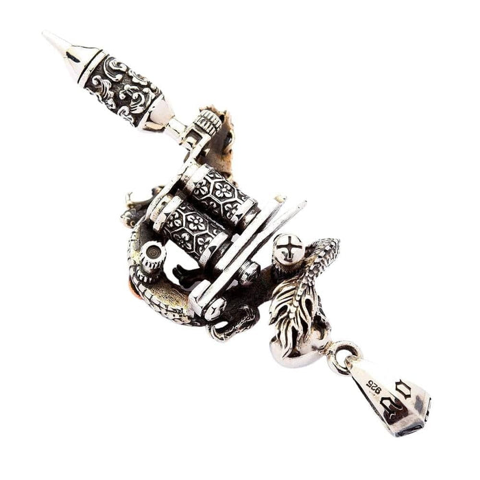 Detailed view of engraved coils and needle tip on silver tattoo machine pendant