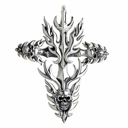 Front view of a silver cross pendant with radiating flames and detailed skulls integrated into the arm ends and base.