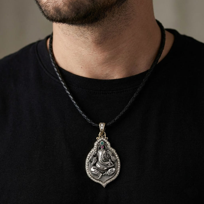 Model wearing the Ganesh sterling silver pendant on a black leather cord, demonstrating the necklace length and size.