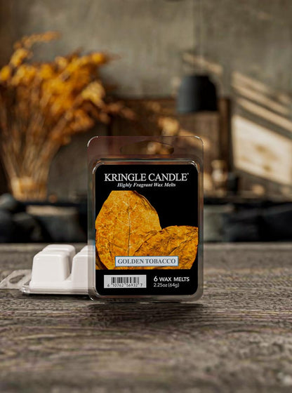 Kringle Candle Golden Tobacco wax melt packaging on a wooden surface with a blurred background