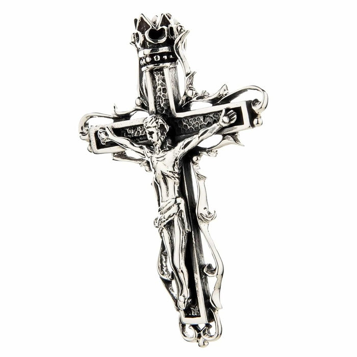 Three-quarter angle view of gothic sterling silver Jesus crucifix pendant showing ornate scrollwork detail