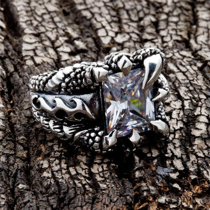 Angled view of Gothic Claw Sterling Silver Ring on textured wood