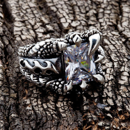 Angled view of Gothic Claw Sterling Silver Ring on textured wood
