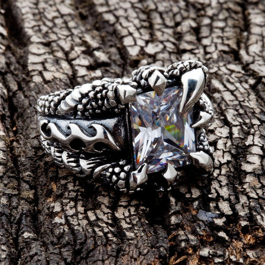 Angled view of Gothic Claw Sterling Silver Ring on textured wood