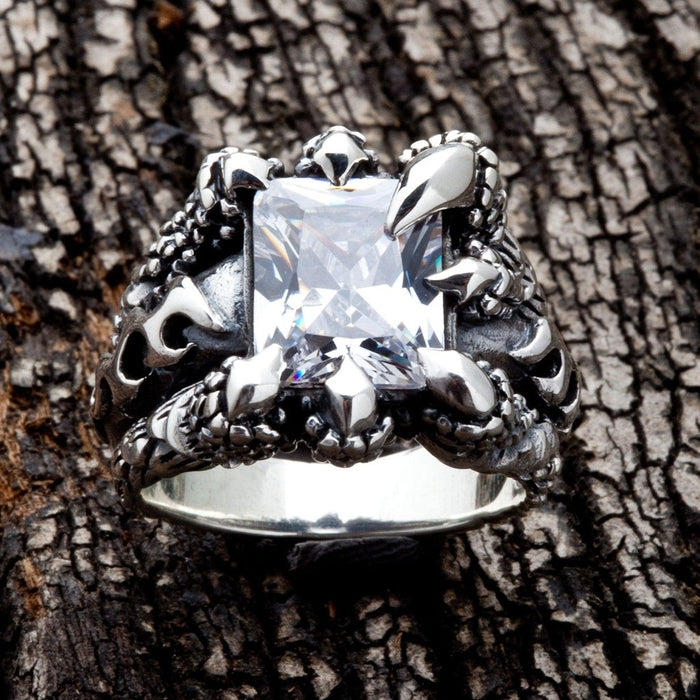 Front view of clear topaz gemstone secured by silver talons