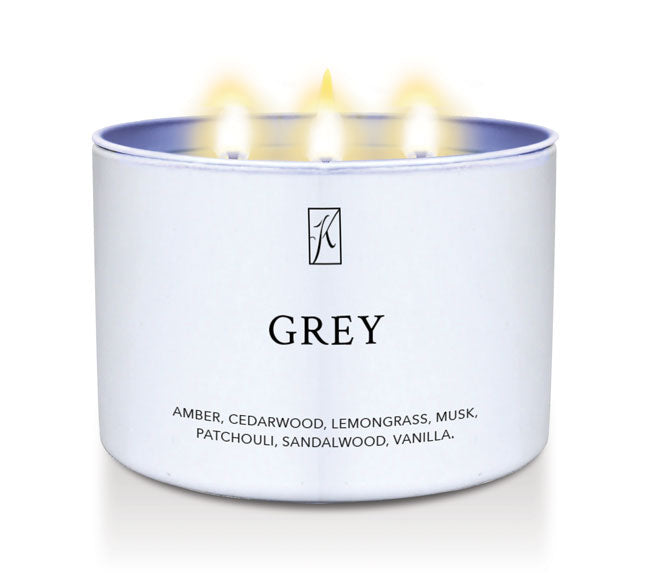 Candle in a white container labeled 'GREY' with a logo, on a white background