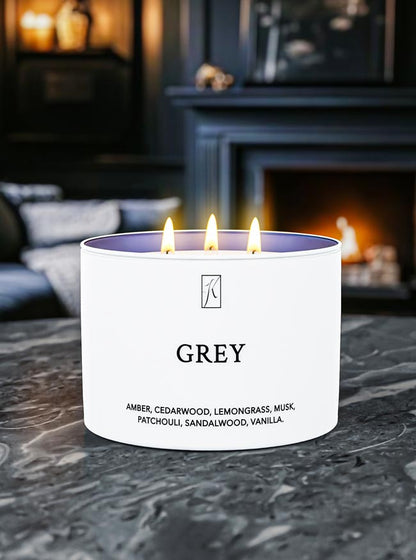 Candle labeled 'GREY' with a fireplace in the background