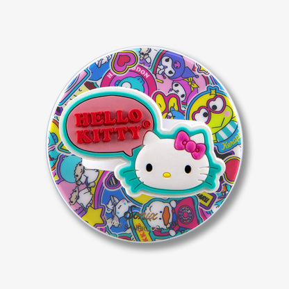 Close-up of magnetic removable phone ring showing red ‘HELLO KITTY’ embossed speech bubble and white Hello Kitty face over colorful character sticker collage on white background