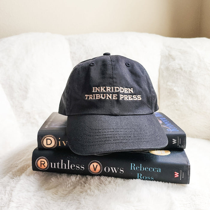 Inkridden Tribune Press War Correspondent Embroidered Bio-Washed Dad Hat - The Bean Workshop - cozy gift, Divine Rivals, divine rivals embroidered hat, hat, Inkridden Tribune, Inkridden Tribune apparel for readers, inkridden tribune press hat for readers, Rebecca Ross, Rebecca Ross book merch, Rebecca Ross fan merchandise