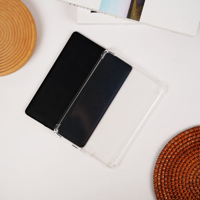 Black notebook with a clear cover on a white surface with woven coasters.