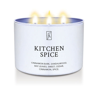 Candle in a white container labeled 'Kitchen Spice' with flames on a white background