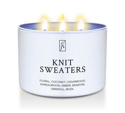 Candle in a white container labeled 'Knit Sweaters' with flames on a white background