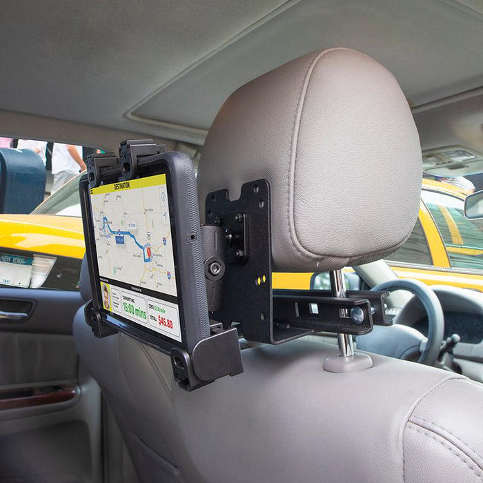 The LockVise™ Locking Car Headrest Tablet Mount secures a tablet to a car seat’s headrest posts, perfect for Uber drivers needing hands-free navigation, with the road visible through the rear window.