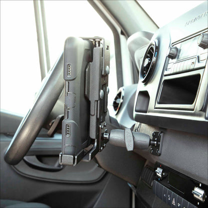 A LockVise™ Metal XL Locking Tablet Holder with Drill Base Mount secures a rugged tablet to the dashboard near the steering wheel and air vent, with control buttons visible below.