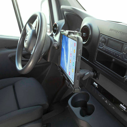 The LockVise™ Metal XL Locking Tablet Holder with Drill Base Mount is securely installed next to the dashboard inside a Mercedes-Benz Sprinter van, showing the steering wheel, cup holders, and control panel.