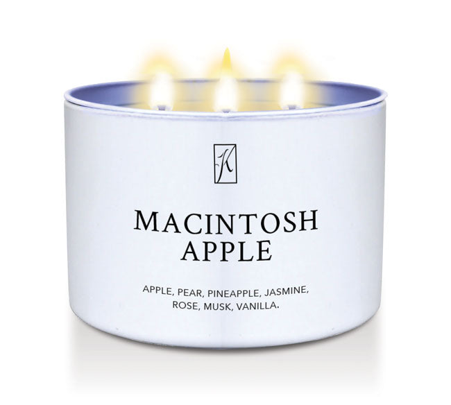 Candle in a white container labeled 'Macintosh Apple' with a logo on a white background