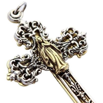 Detailed close-up of the warm brass angel figure set against the polished sterling silver scrollwork cross.