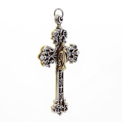 Angled profile revealing the layered depth of the double-cross pendant, showing silver scrollwork over a warm brass base.