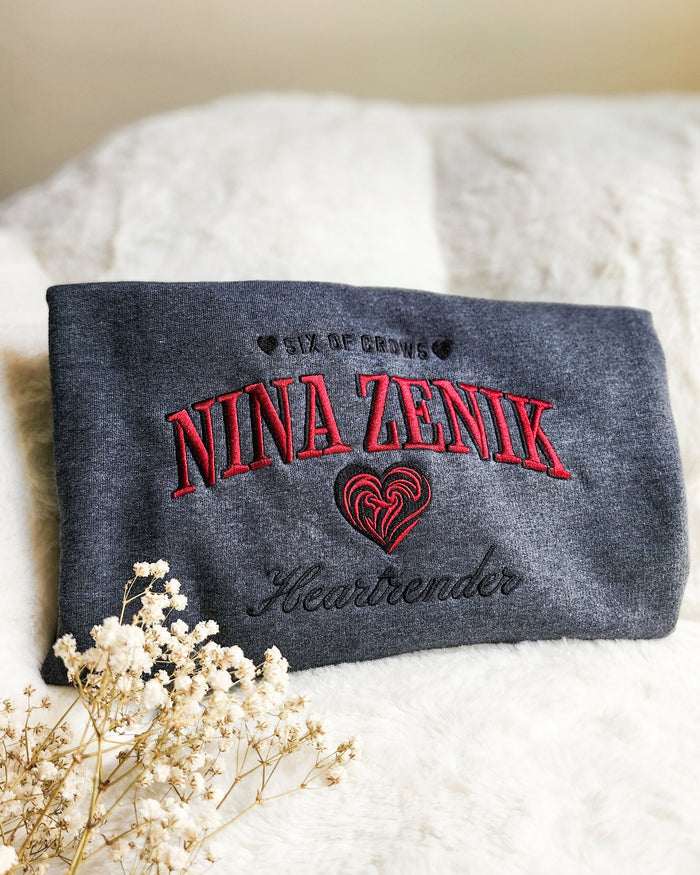 Nina Zenik Embroidered Sweatshirt - The Bean Workshop - Book Lover Gift, Bookish Sweatshirt, Corporalnik, Fantasy Character, Grisha Order clothing, Grishaverse, Helnik, Leigh Bardugo fan apparel for readers, Nina Zenik embroidered sweatshirt, Powerful Female Character, Six of Crows Heartrender merch, The Dregs, Waffle Lover